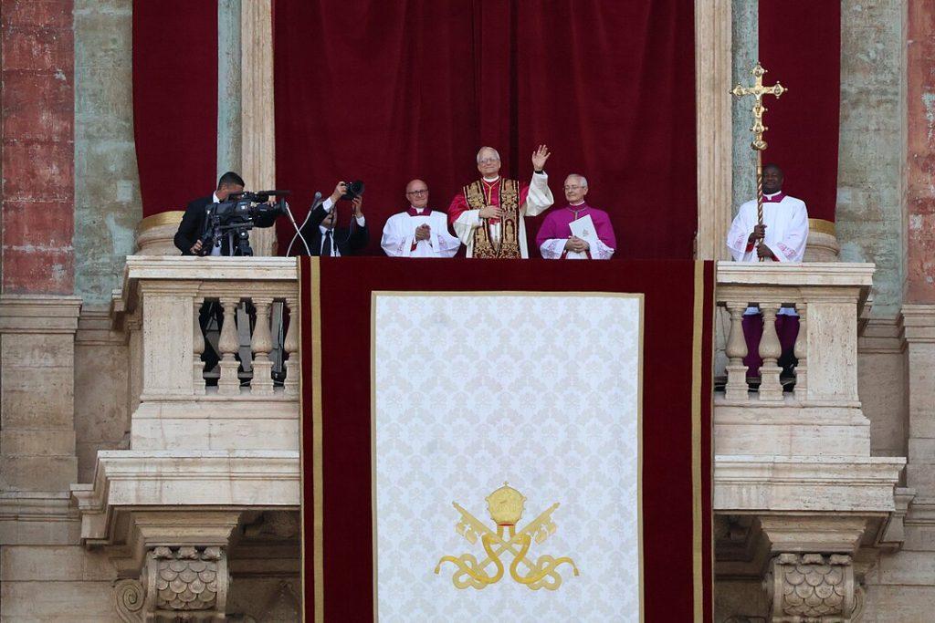 Pope Leo XIV waving from the loggia of St. Peter's Basilica in his first public appearance